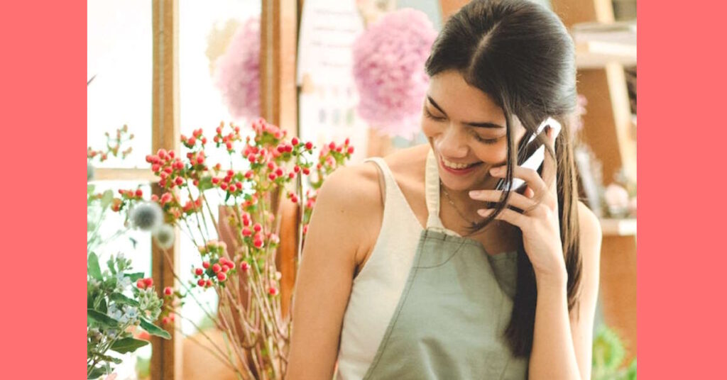 Woman florist business owner talking on phone