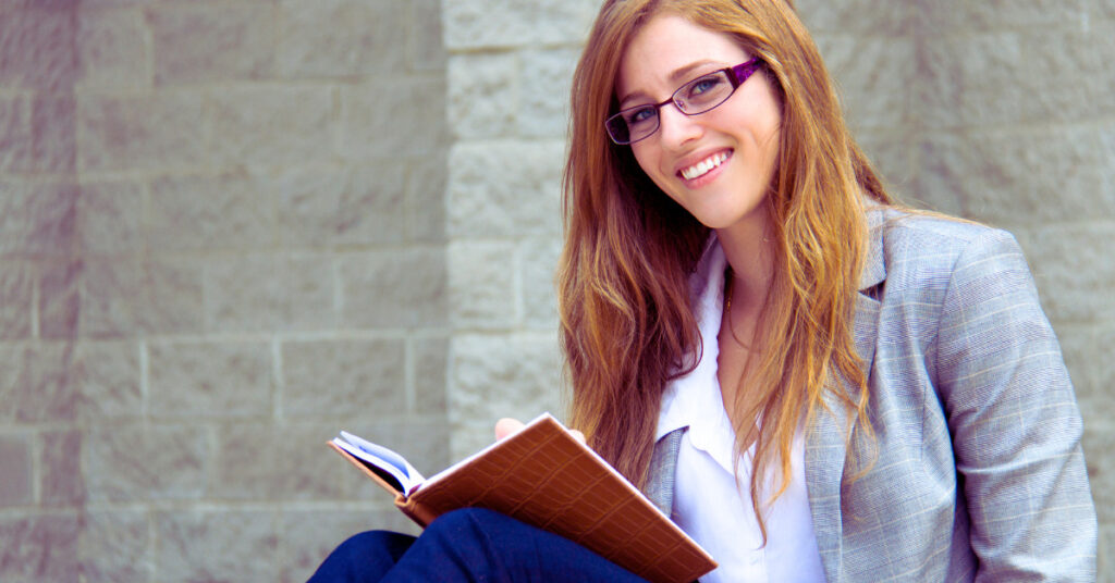 business woman outside in front of business journaling